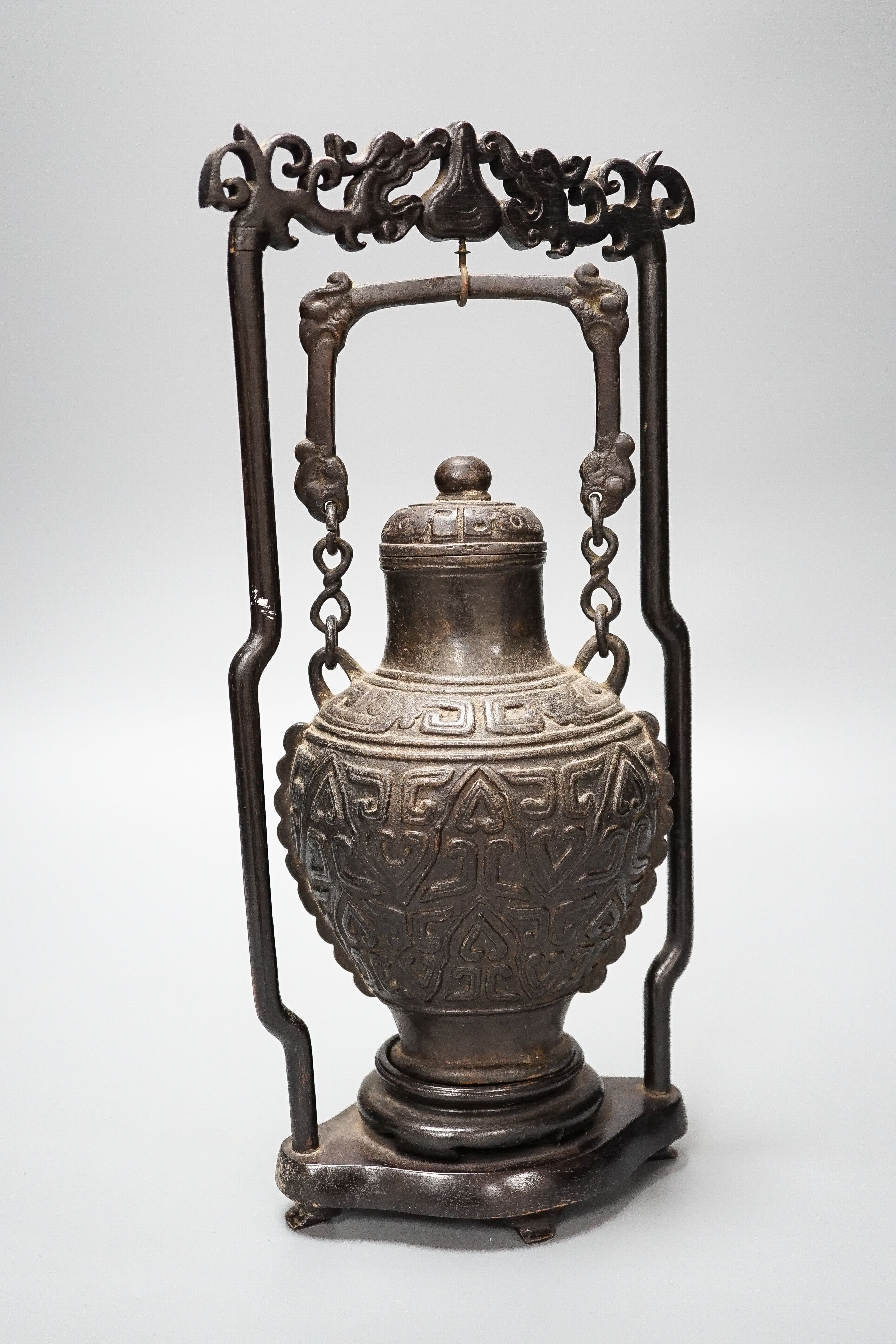 A Chinese archaistic bronze hanging vessel, wood stand 34cm